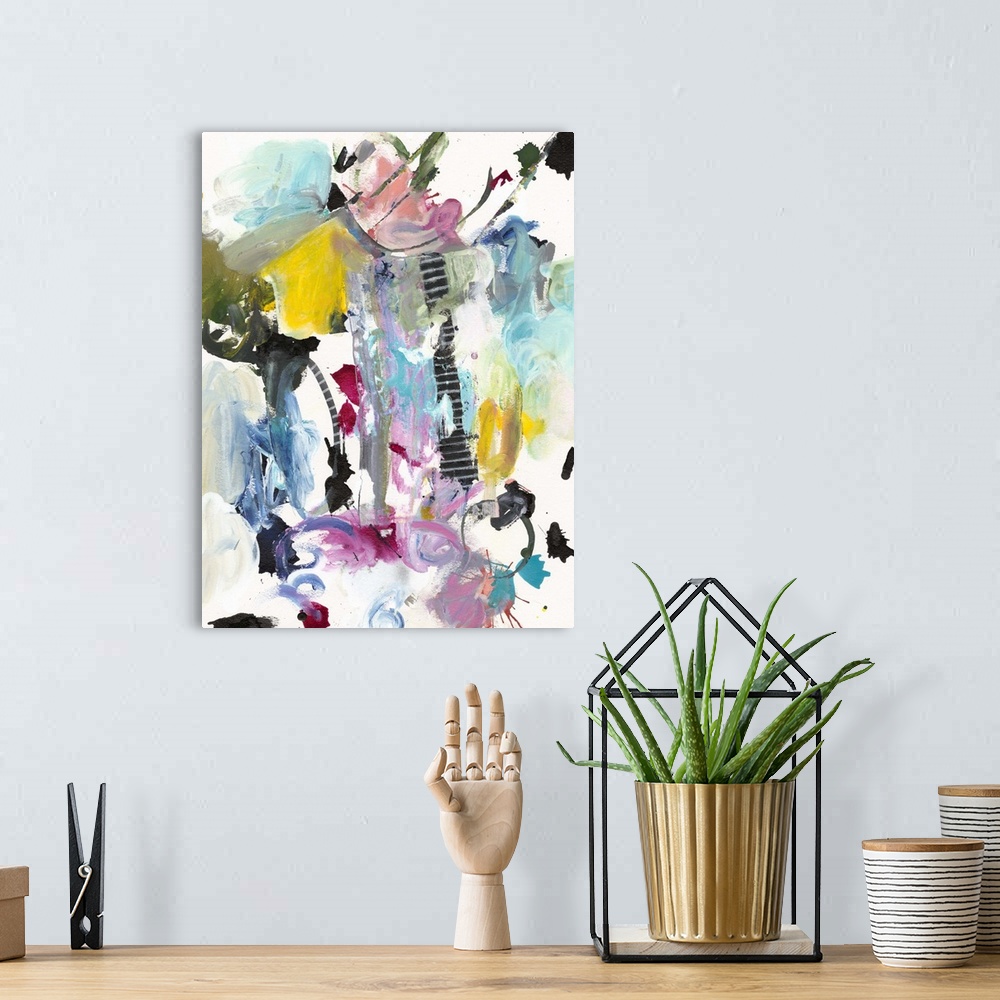 A bohemian room featuring Abstract painting in wild splashes and splatters of pink, teal, yellow, and black.