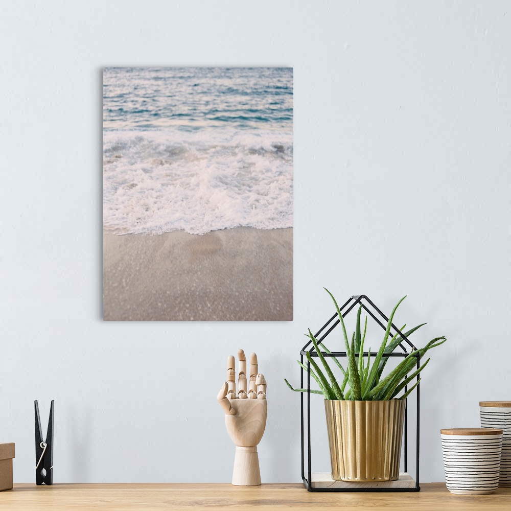 A bohemian room featuring A photograph of waves lapping the beach.