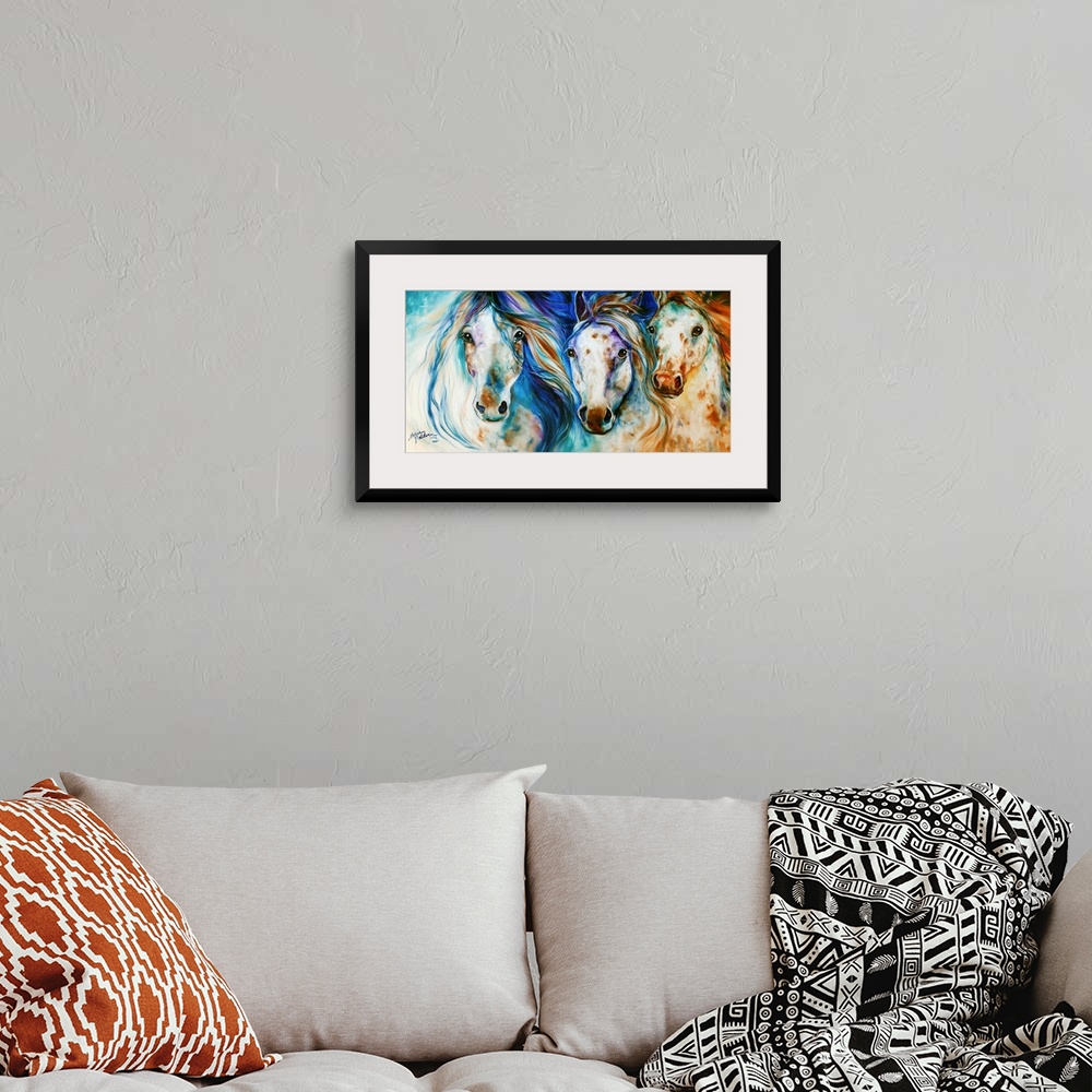 A bohemian room featuring Panoramic painting of three Appaloosa horses with playful hues and beautifully flowing manes.
