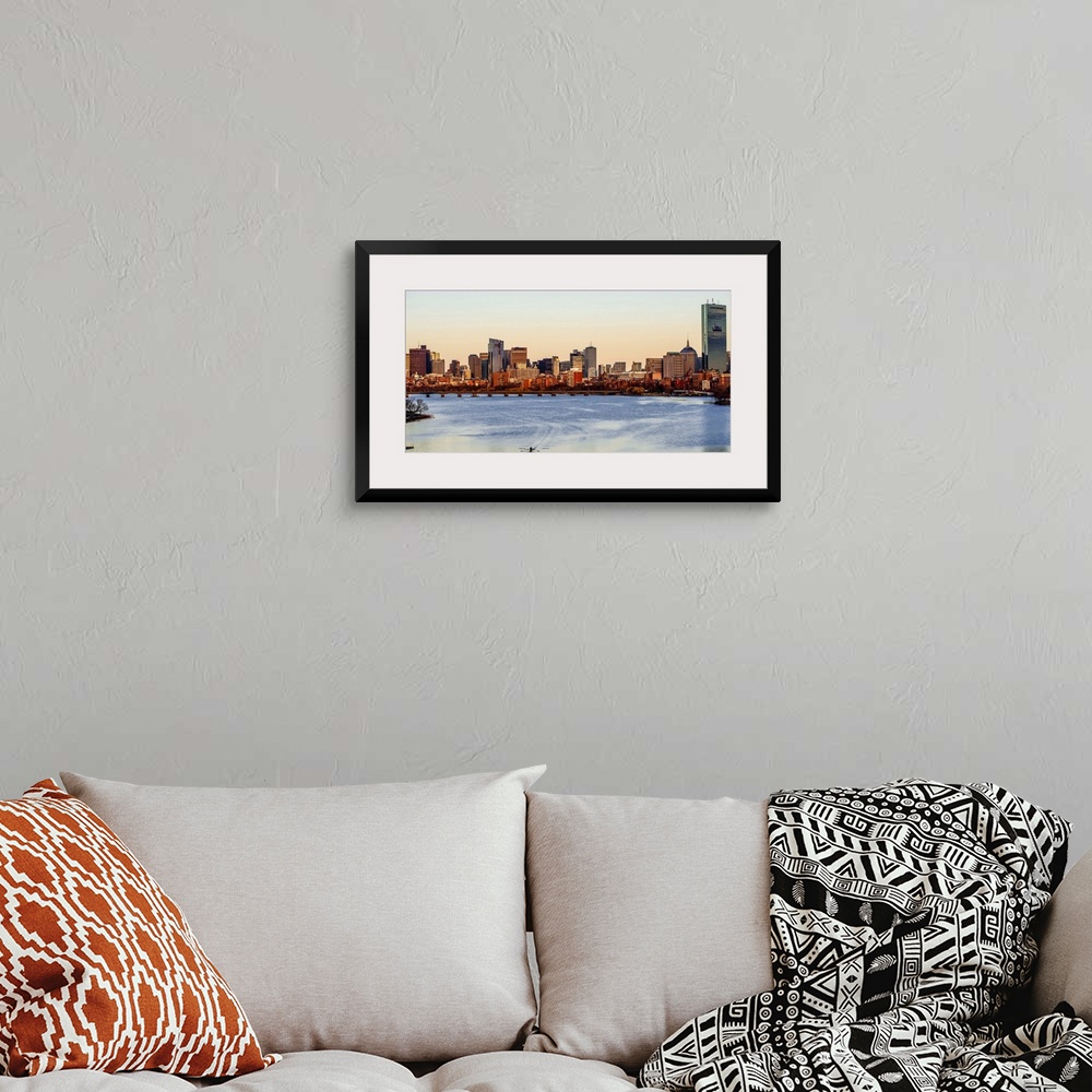 A bohemian room featuring Panoramic view of the Boston City skyline at sunset, seen from across the water.