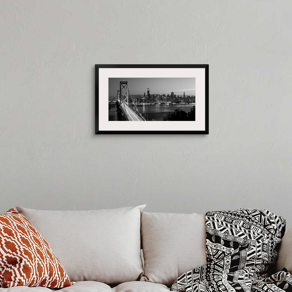 A bohemian room featuring Photograph of the Bay Bridge with a sunset and the San Francisco skyline lit up in the background.