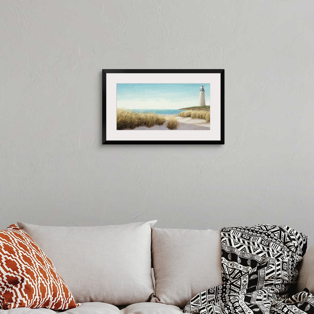 A bohemian room featuring Horizontal, large wall picture of grasses blowing on the beach.  A lighthouse in the distance, ne...