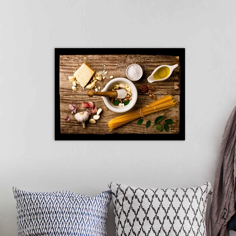 A bohemian room featuring Spread of ingredients for pesto arranged on a wooden board and in a mortar and pestle.
