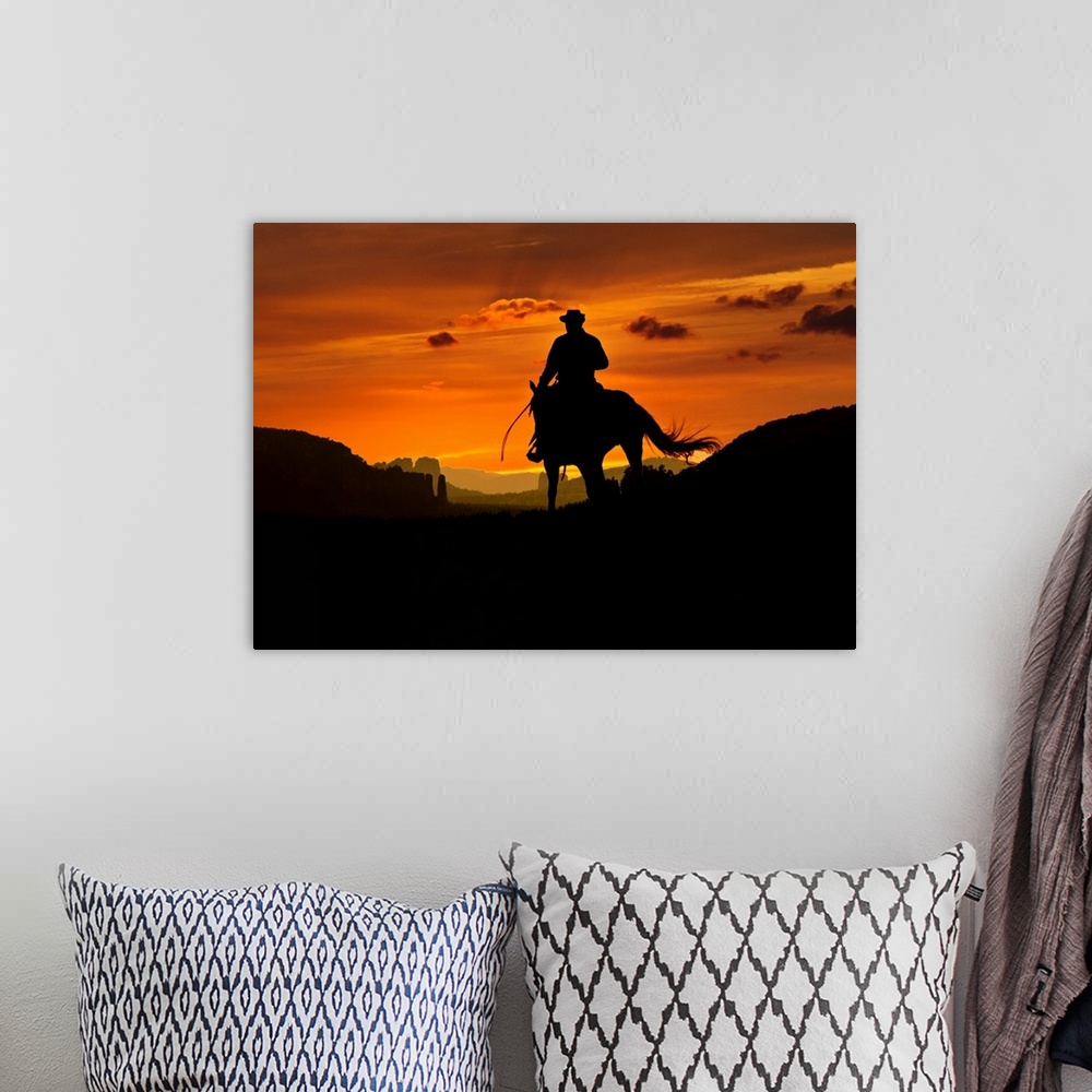 A bohemian room featuring Cowboy is riding through a valley in the night. Composition of two images.