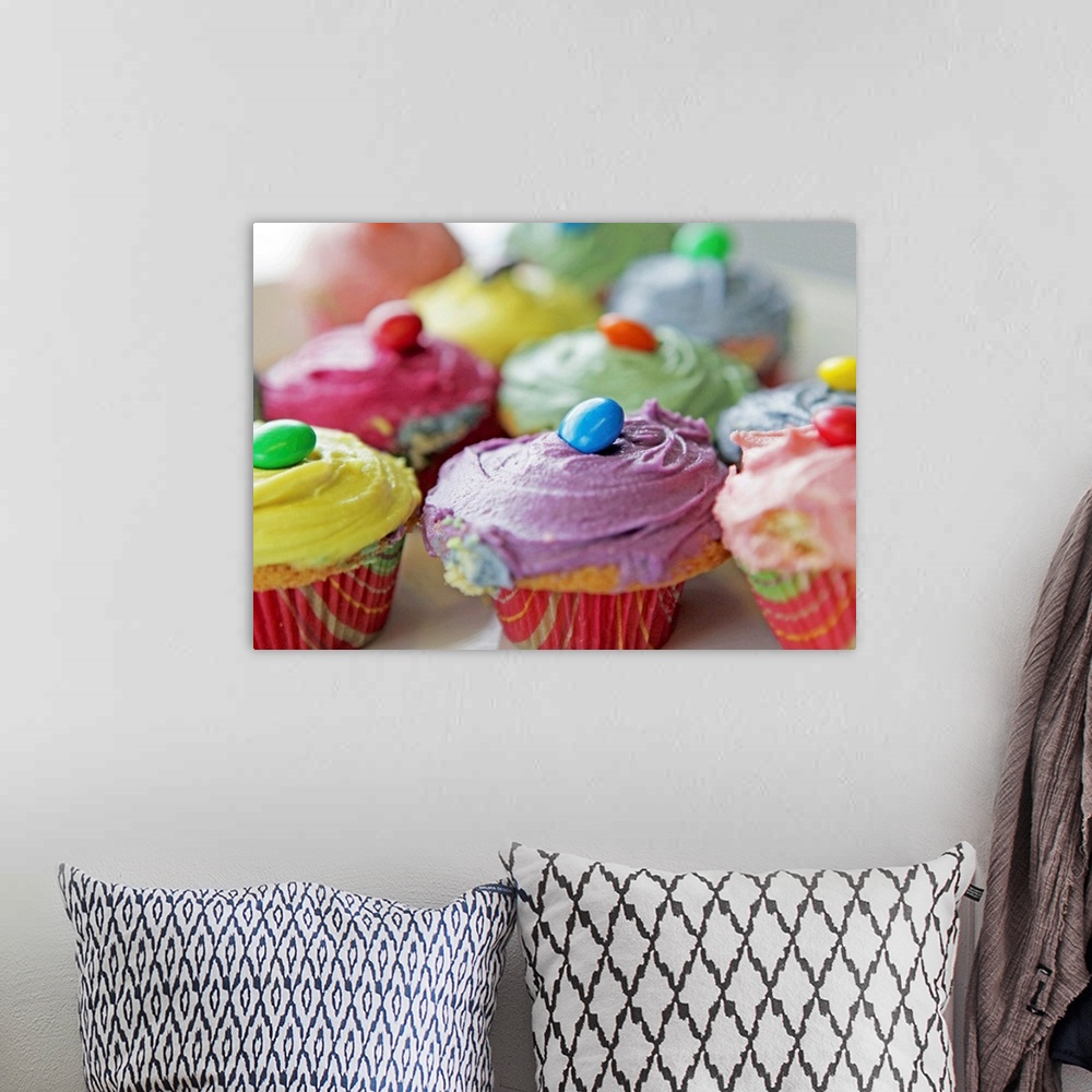A bohemian room featuring Various colorful homemade cupcakes.
