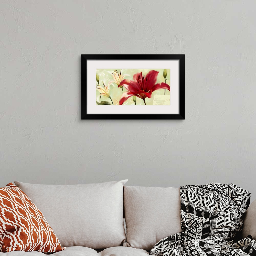 A bohemian room featuring Home decor artwork of vibrant red and white lilies against a green background.