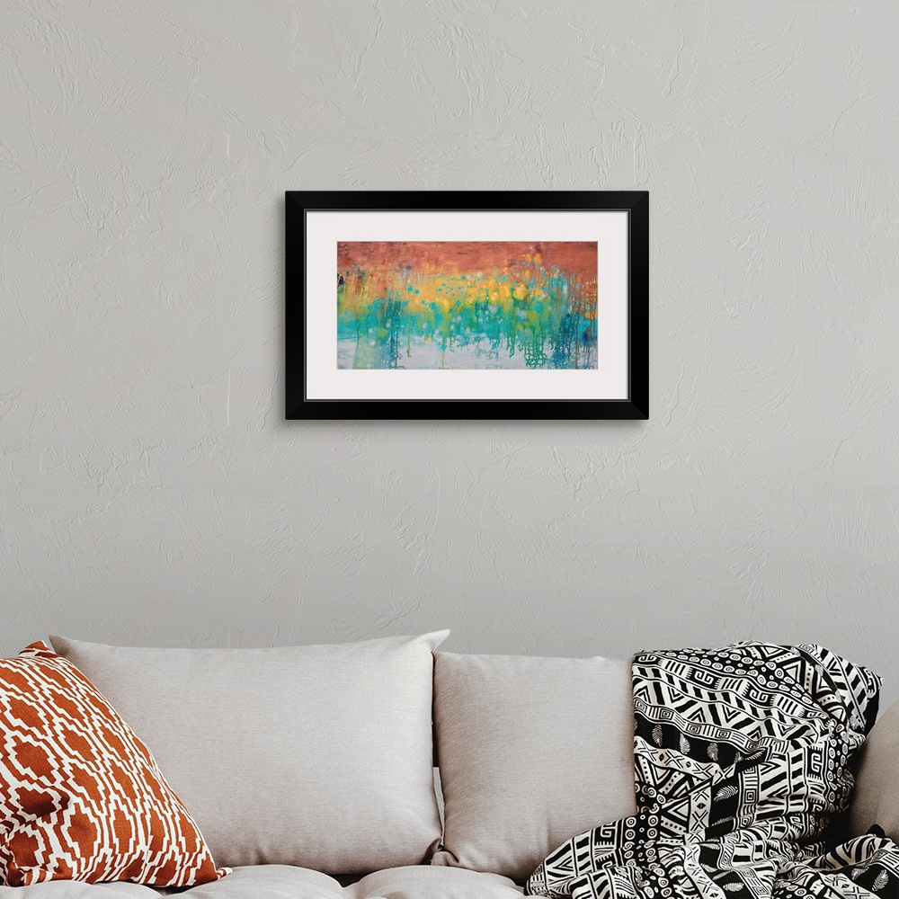 A bohemian room featuring A contemporary abstract painting using a spectrum of color in a horizontal formation.