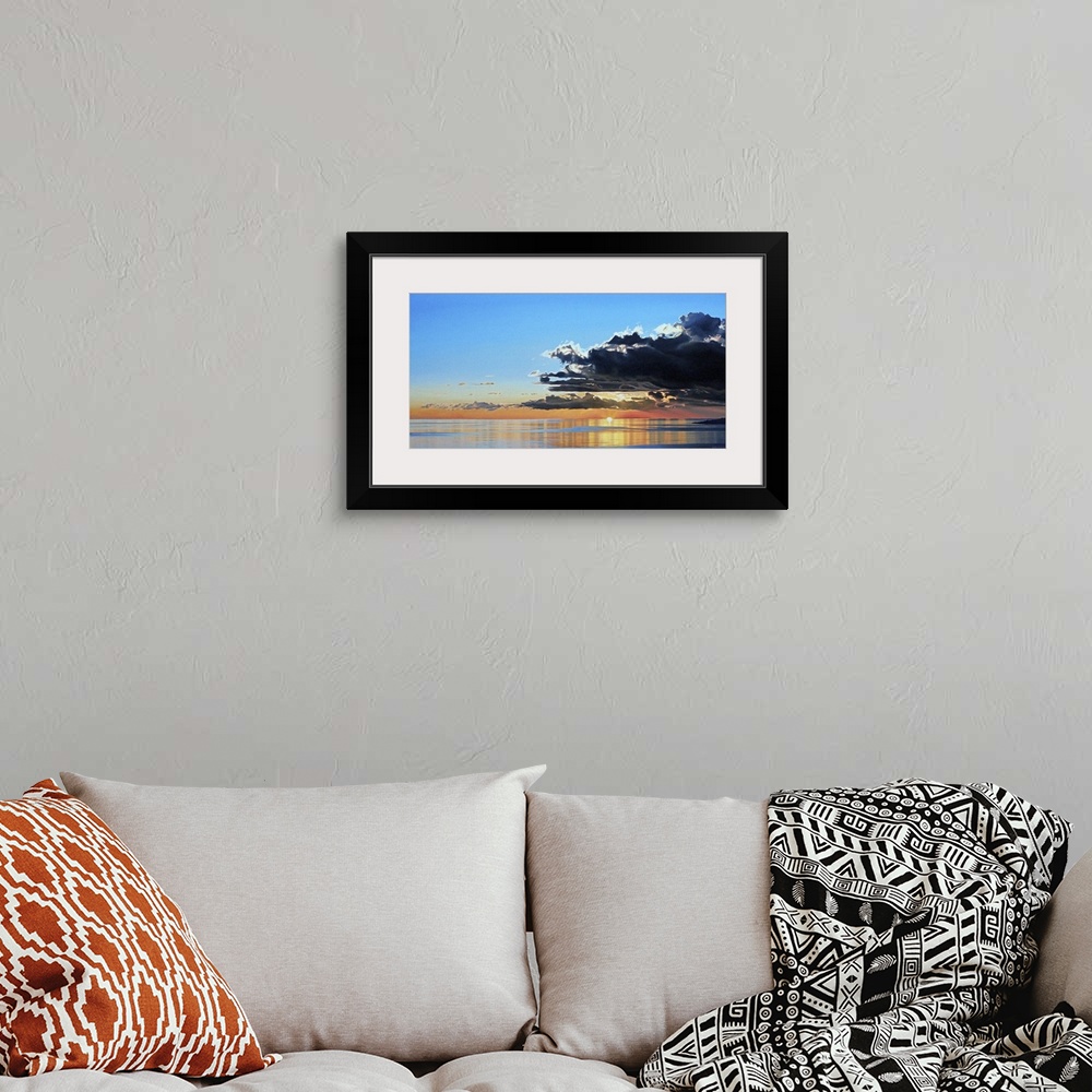 A bohemian room featuring Contemporary painting of a seascape with dark clouds rolling in.