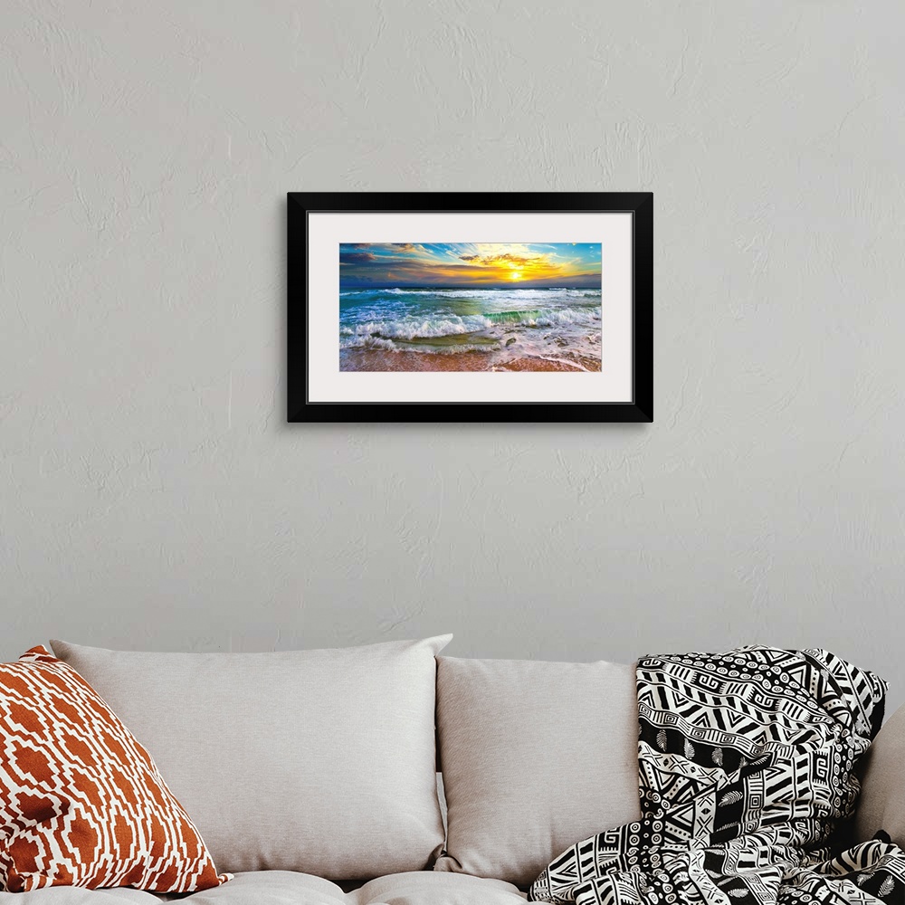 A bohemian room featuring This panoramic beach sunset features breaking waves on a beautiful sea shore. A wave crashes on t...