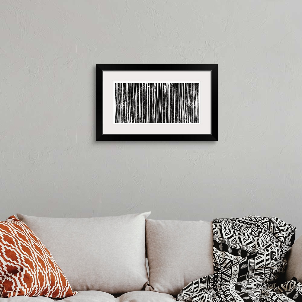 A bohemian room featuring Abstract artwork of several vertical black and white lines.