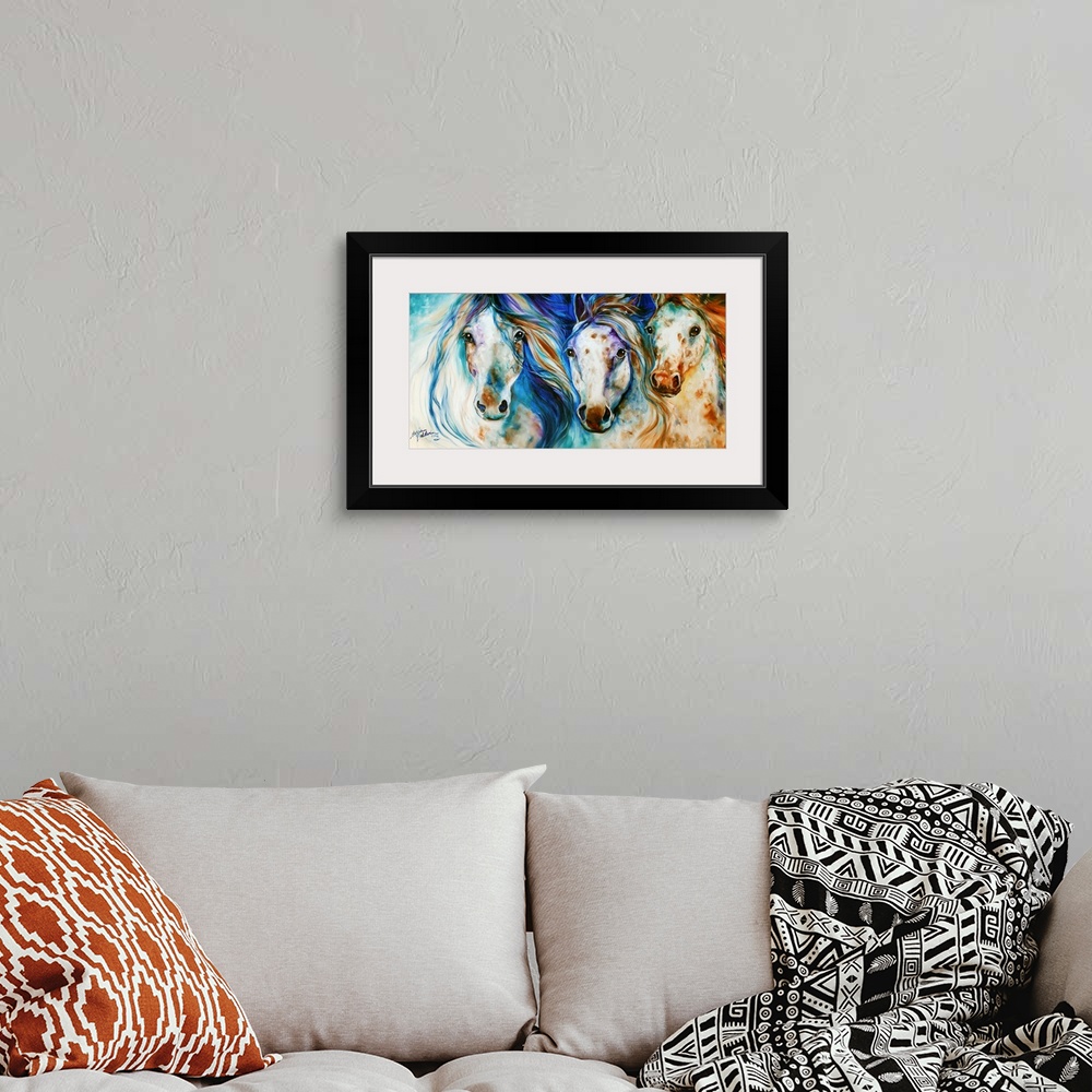 A bohemian room featuring Panoramic painting of three Appaloosa horses with playful hues and beautifully flowing manes.