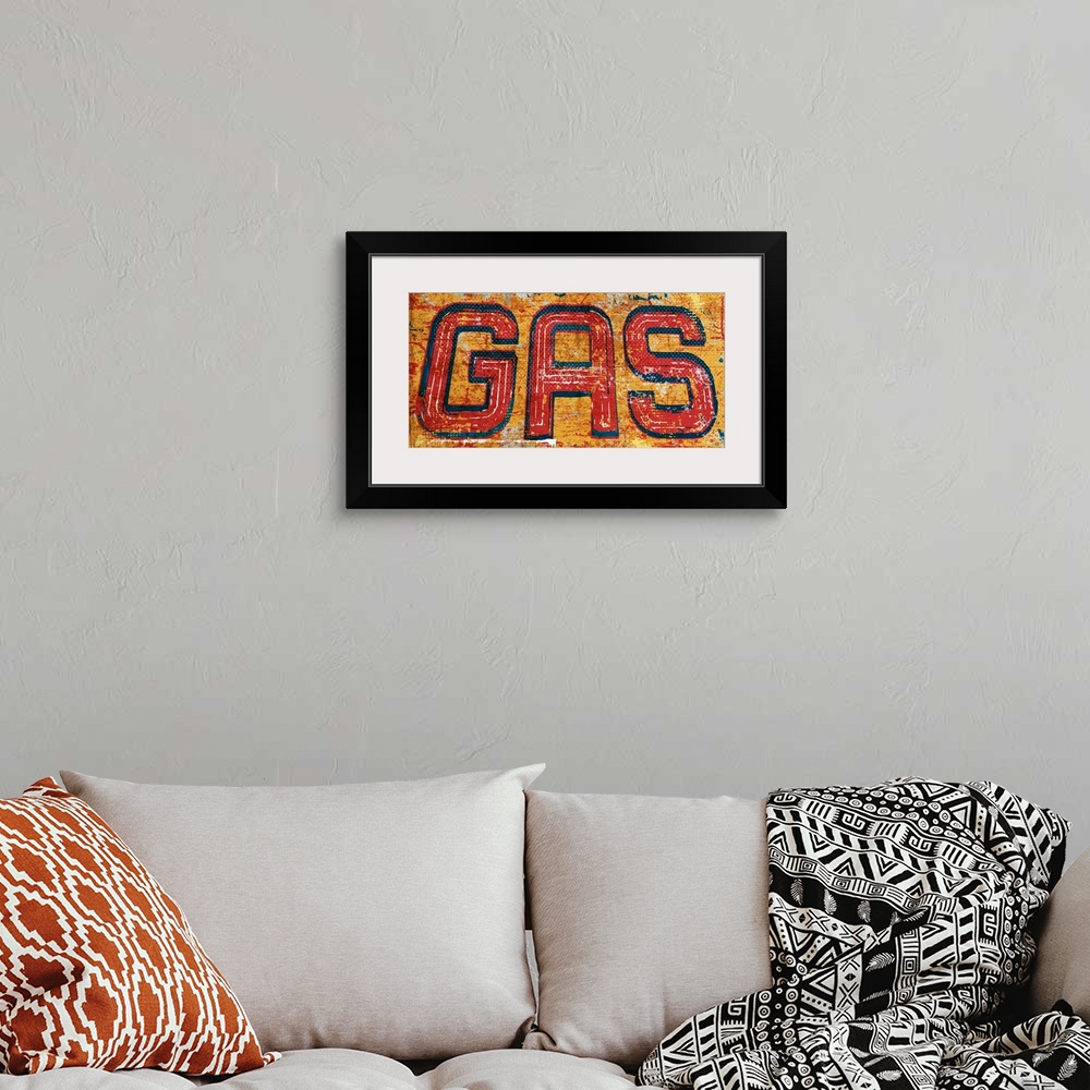 A bohemian room featuring Graphic rusty wall art of distressed typography with the the word GAS large and in center on a ye...