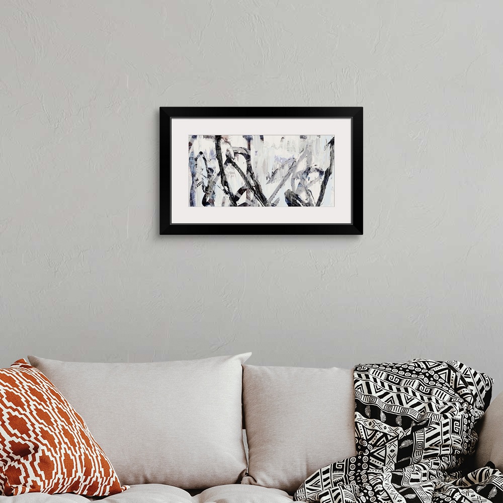A bohemian room featuring Contemporary abstract artwork in shades of grey and black.