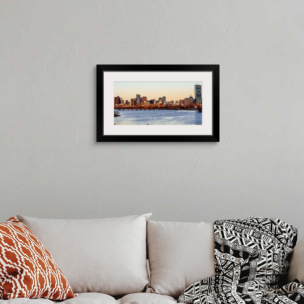 A bohemian room featuring Panoramic view of the Boston City skyline at sunset, seen from across the water.