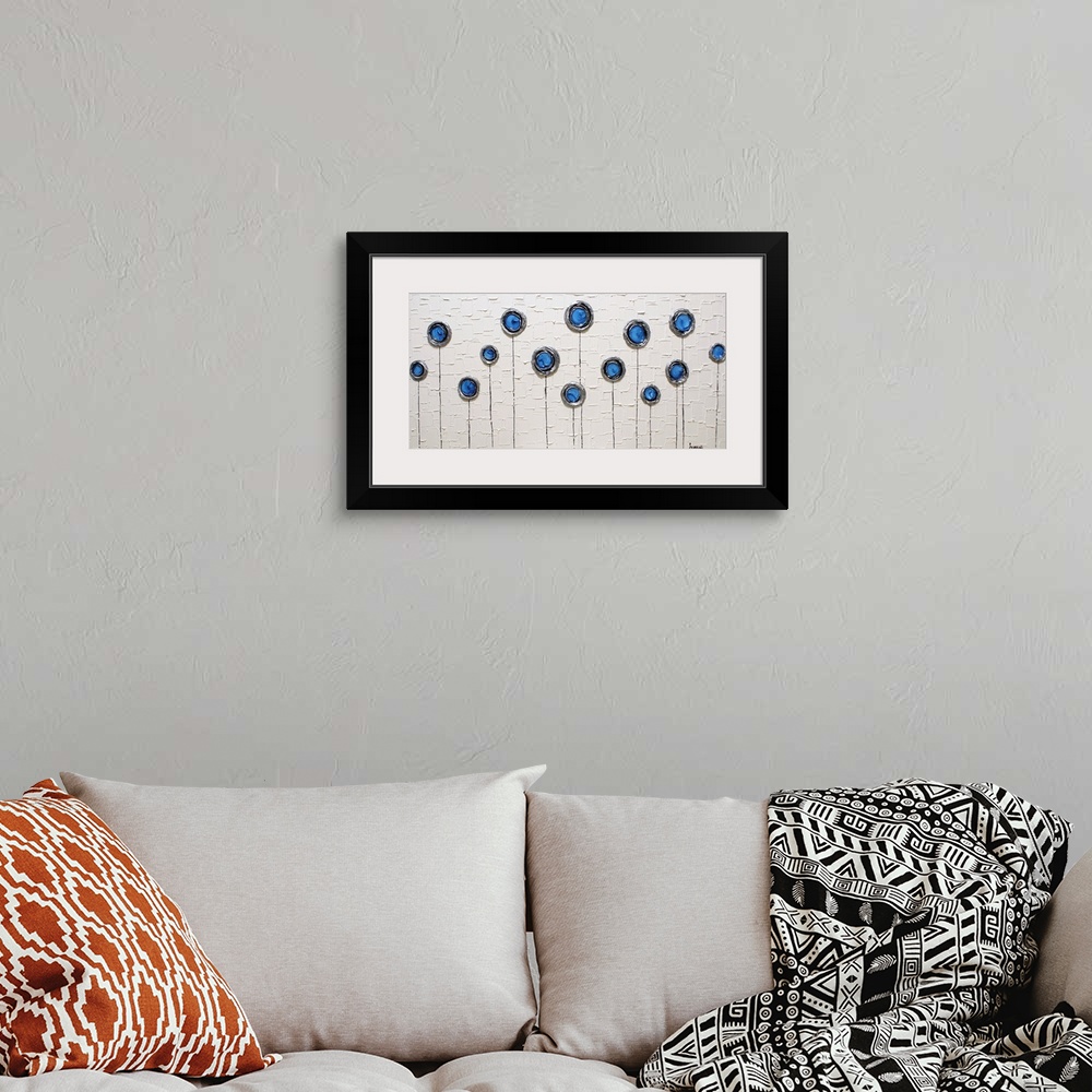 A bohemian room featuring Wide abstract painting with blue, silver, and black layered circles with thin stems running to th...