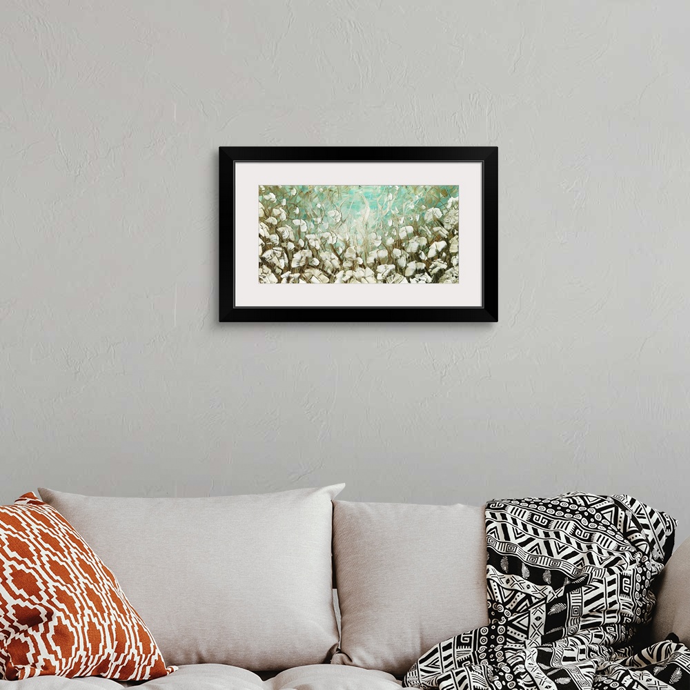 A bohemian room featuring Large abstract landscape painting with cream colored poppy flowers on a light blue and brown back...