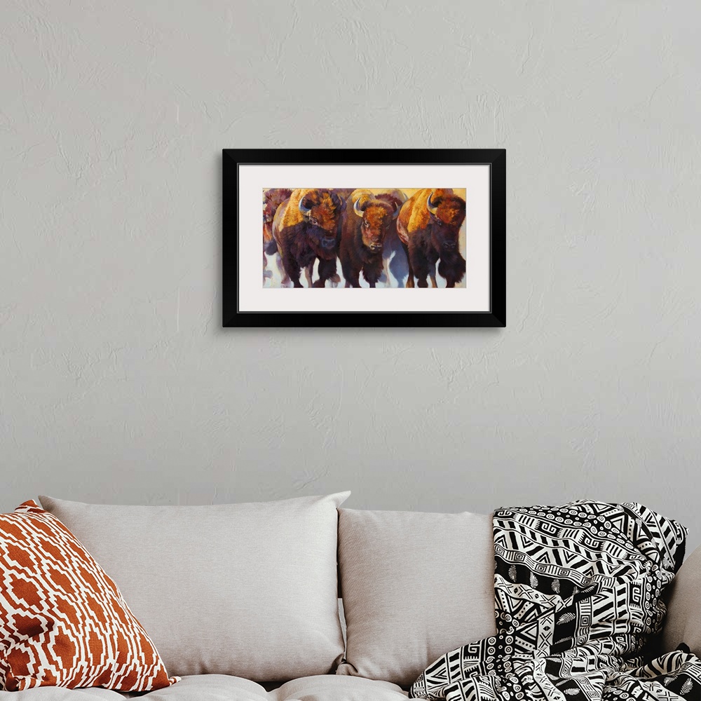 A bohemian room featuring Painting on canvas of bison and buffalos running in a pack.