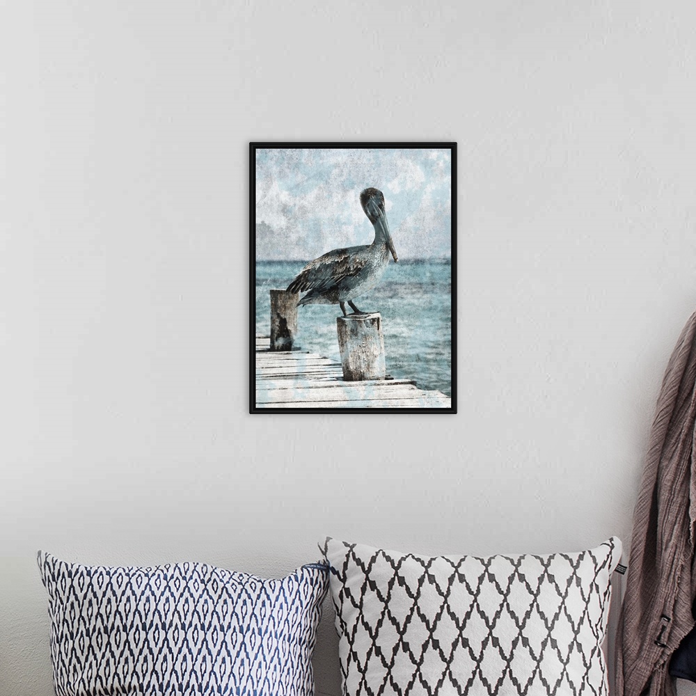 A bohemian room featuring Black and white photograph of a pelican standing on a dock with light blue tones painted on top.