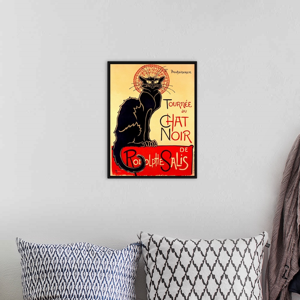 A bohemian room featuring Painting of a large black cat staring at the viewer with text.