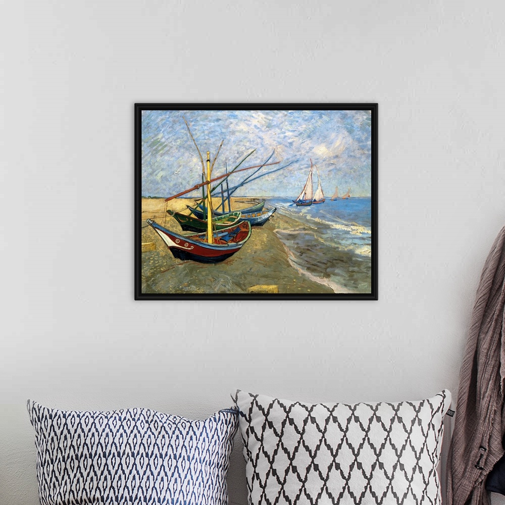 A bohemian room featuring Classical painting of fishing vessels docked on sand with sailboats sailing just off the shore on...