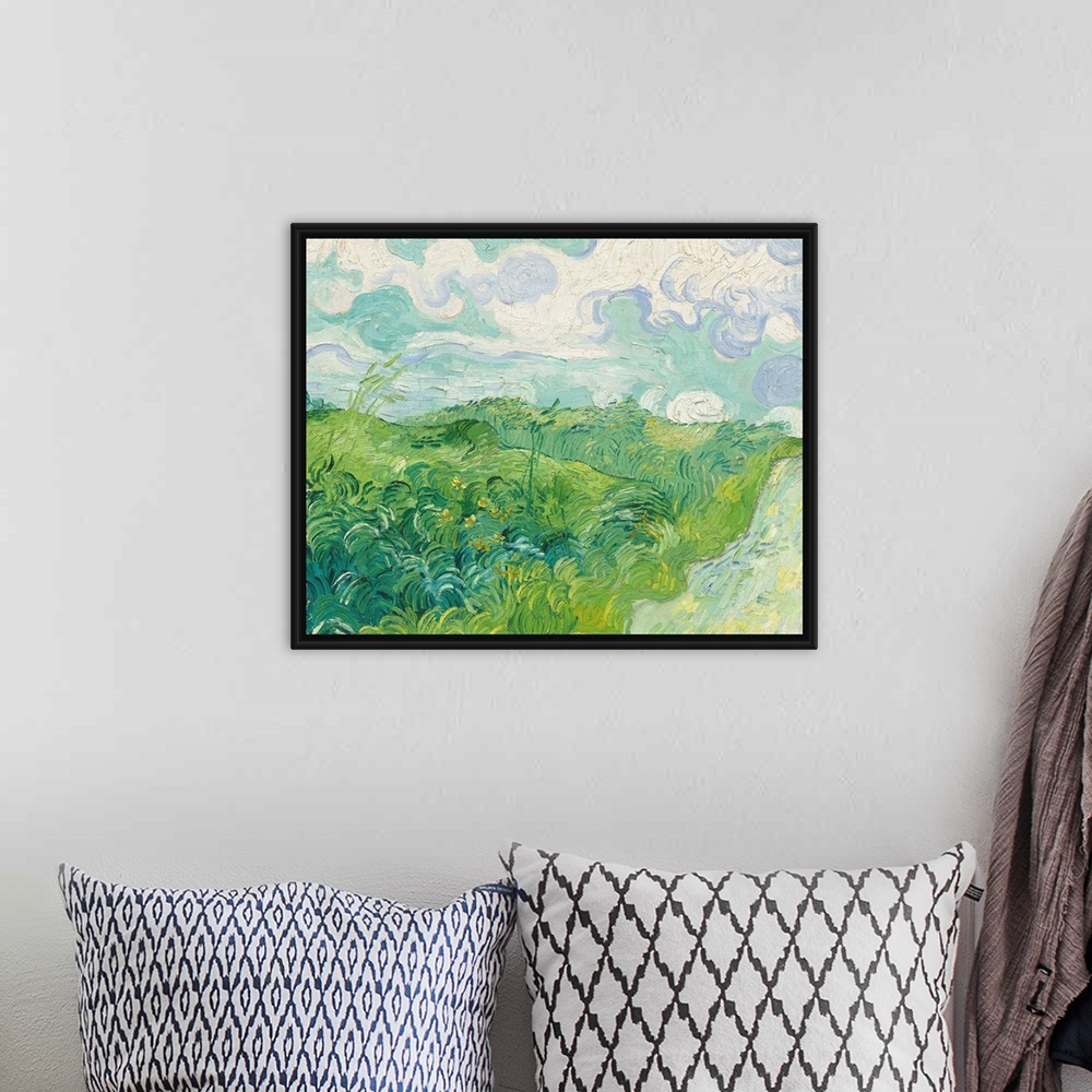 A bohemian room featuring Painting of a green countryside field by Vincent Van Gogh.