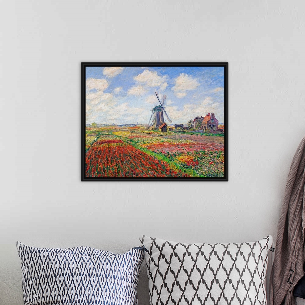 A bohemian room featuring Oil painting of a windmill in a field of bright flowers under a sky with puffy clouds.