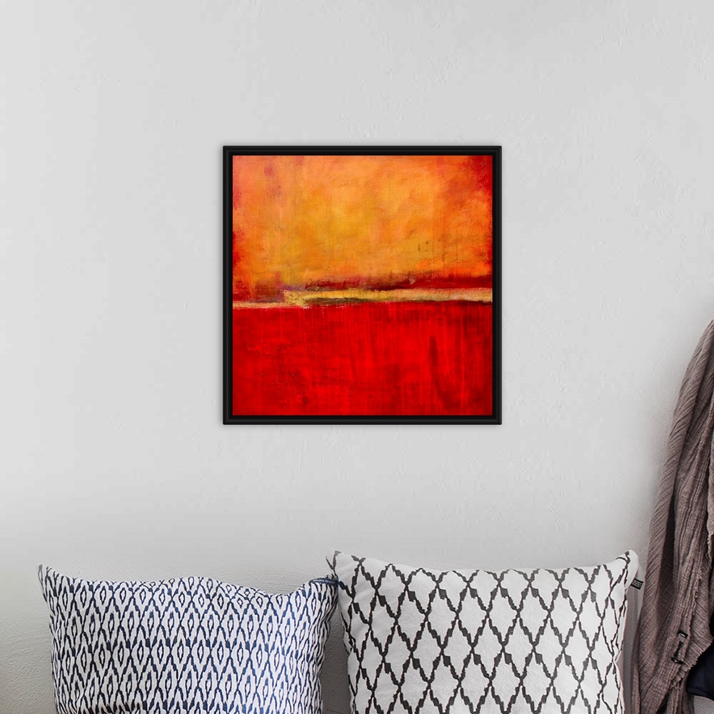 A bohemian room featuring Square abstract artwork in fiery red and orange tones with simple, bold areas of color, resemblin...