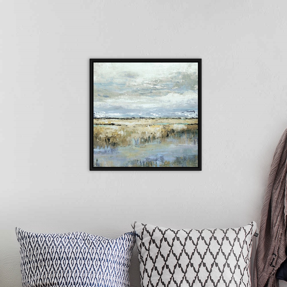 A bohemian room featuring Square abstract painting of a marsh landscape in shades of brown, blue, yellow, and grey.