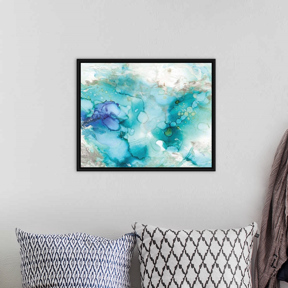 A bohemian room featuring Large abstract watercolor painting in shades of blue, grey, and green marbling together.