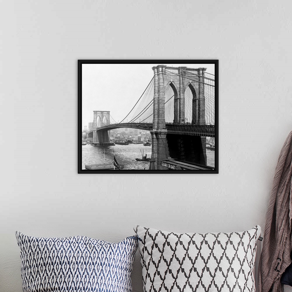 A bohemian room featuring A view of the Brooklyn Bridge which spans across the East River connecting Manhattan Island to Br...