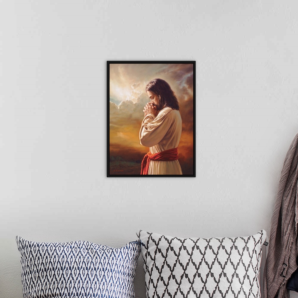 A bohemian room featuring Fine art painting of Jesus praying in front of a sunset while wearing a red belt.