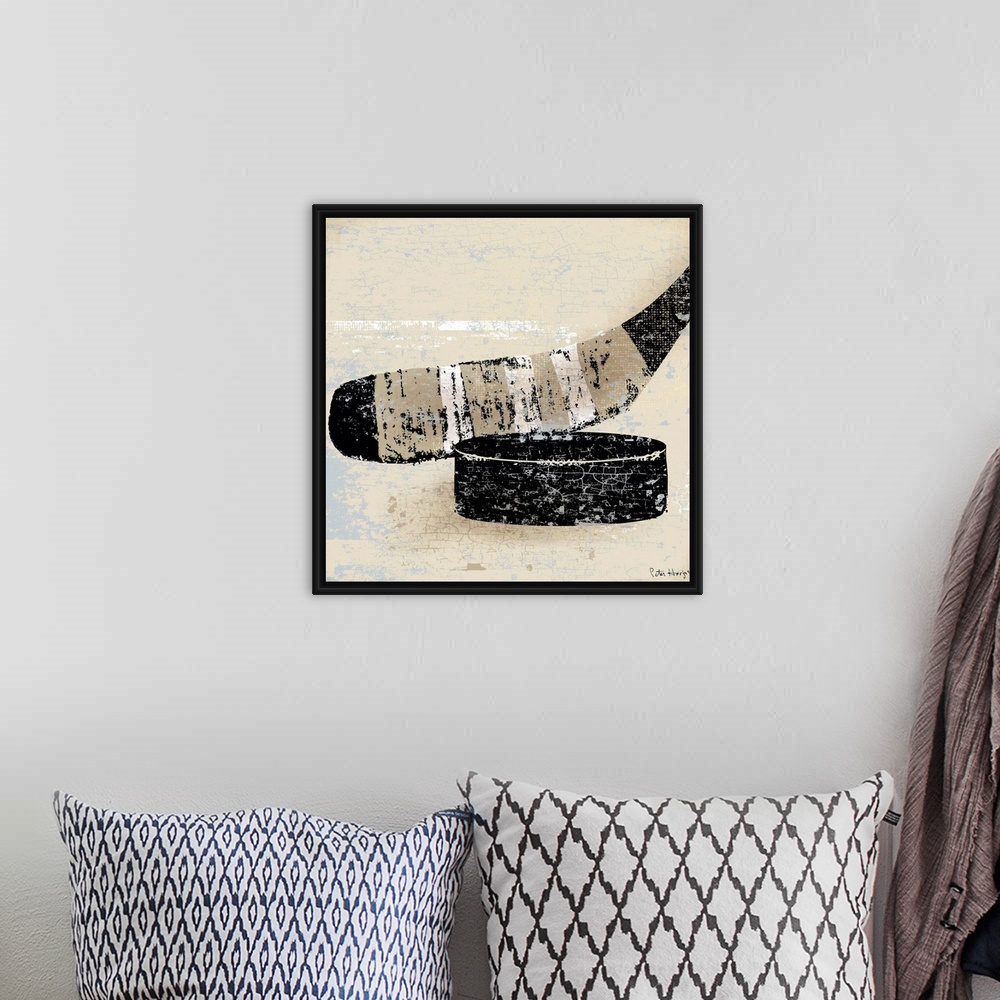 A bohemian room featuring Vintage style wall art of an old distressed hockey stick and puck on tan and sepia background.