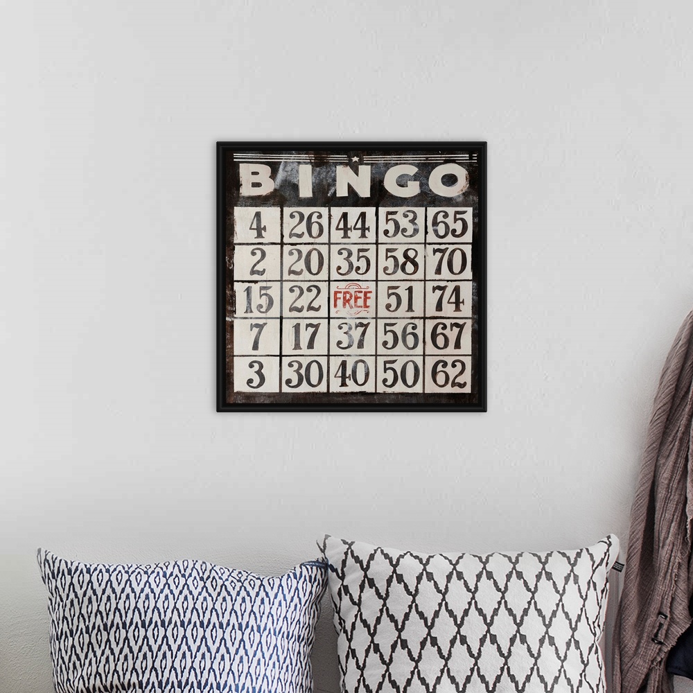 A bohemian room featuring This large piece has an antique style Bingo card that takes up the entire face of artwork.