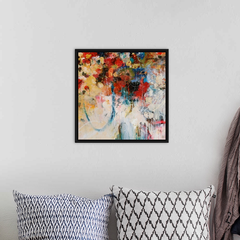 A bohemian room featuring Abstractly painted square canvas with different flowers painted in the top portion and faded colo...