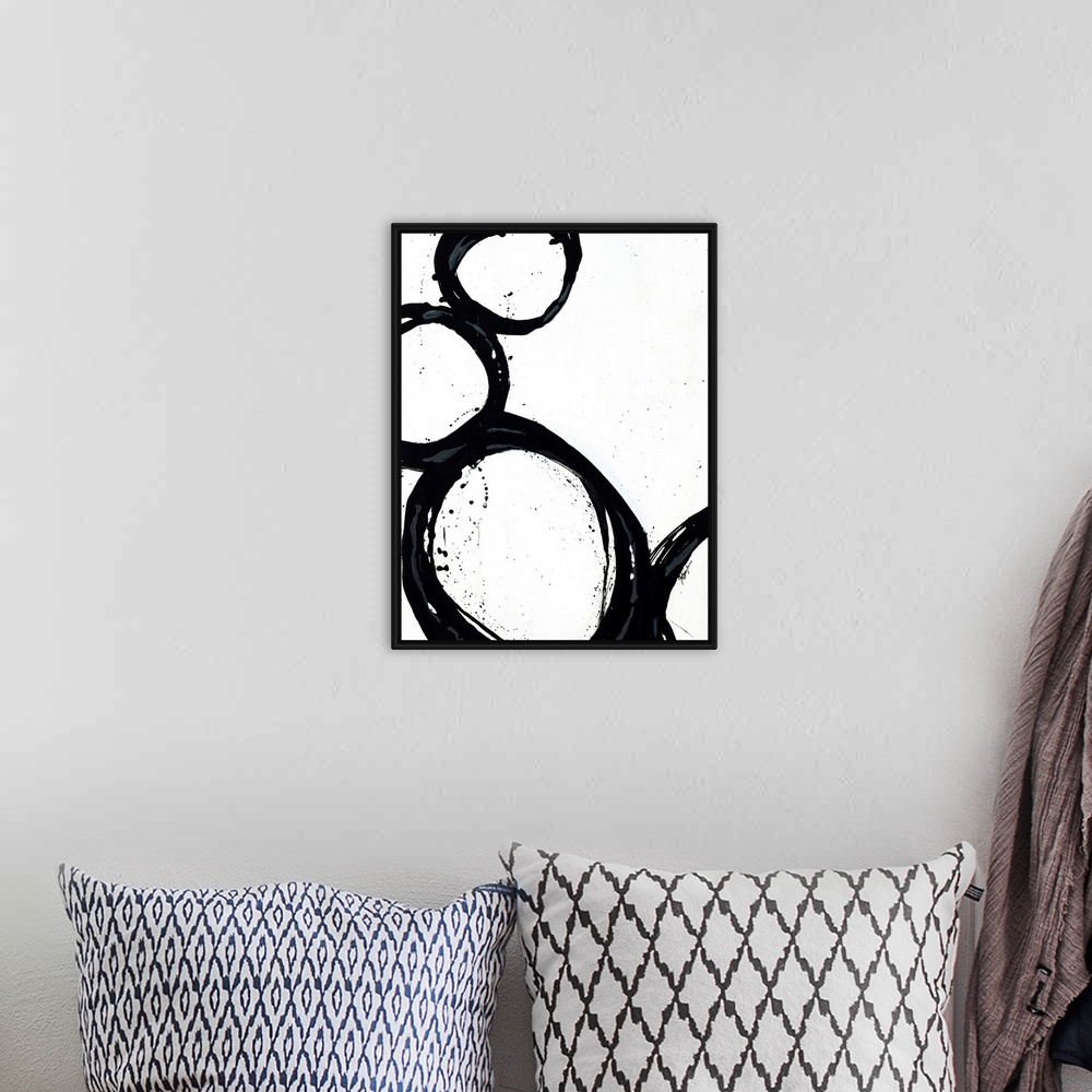 A bohemian room featuring Large abstract art includes four circles with thick borders as they sit against and on top of eac...