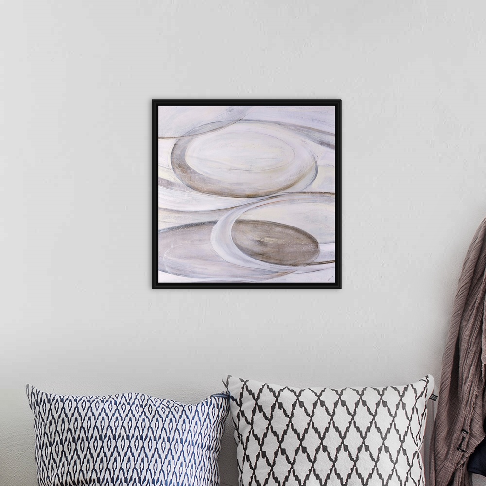 A bohemian room featuring Monochromatic abstract art of ovular shapes in various shades of cream.