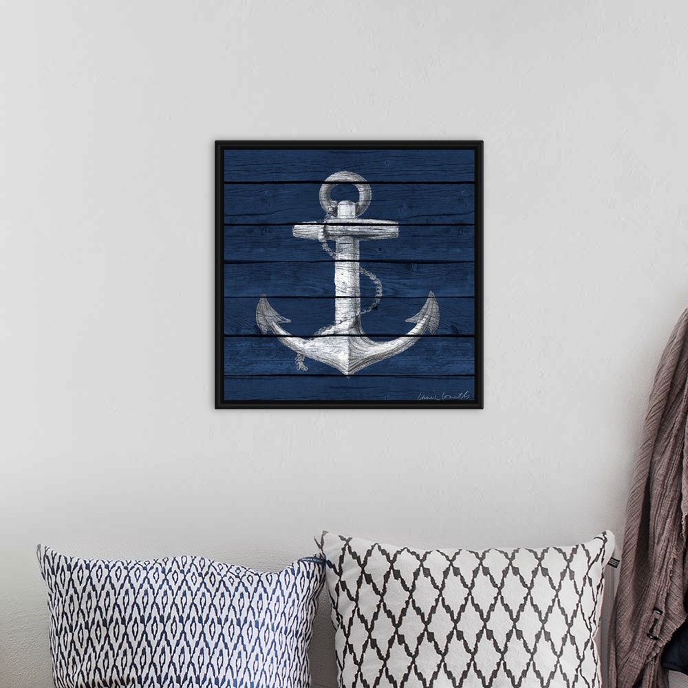 A bohemian room featuring A painting of an anchor on a blue wood paneled background.