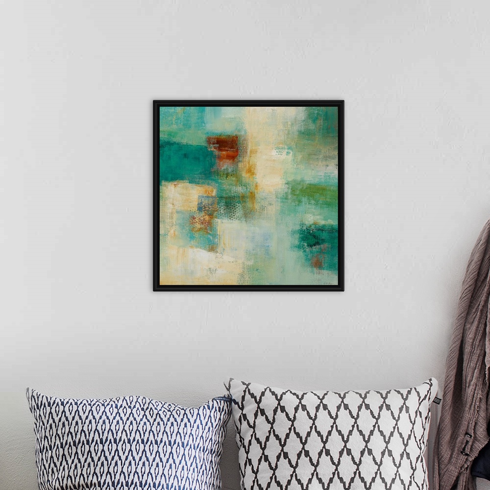 A bohemian room featuring Square abstract painting with warm and cool patches of color in rough textures.