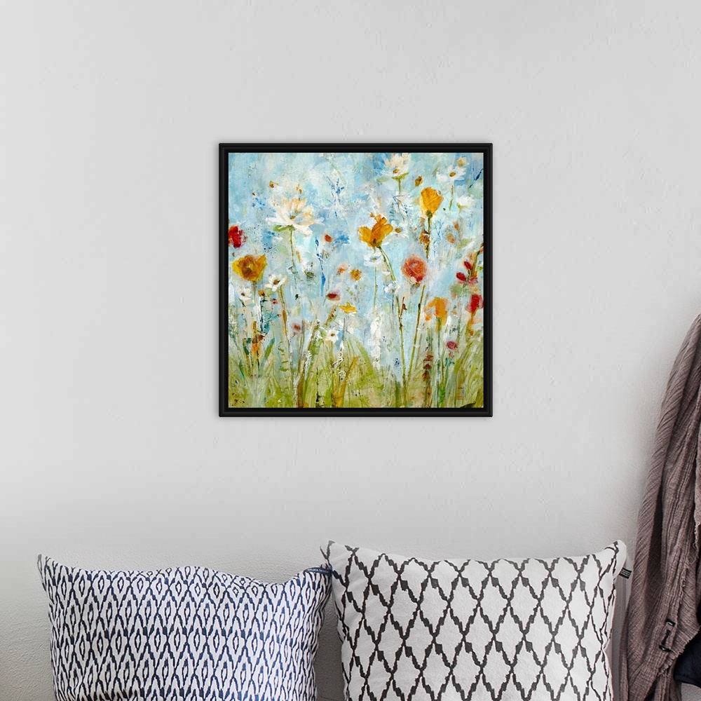 A bohemian room featuring A vertical abstract landscape painting of loosely painted flowers and grass that reminiscent of a...
