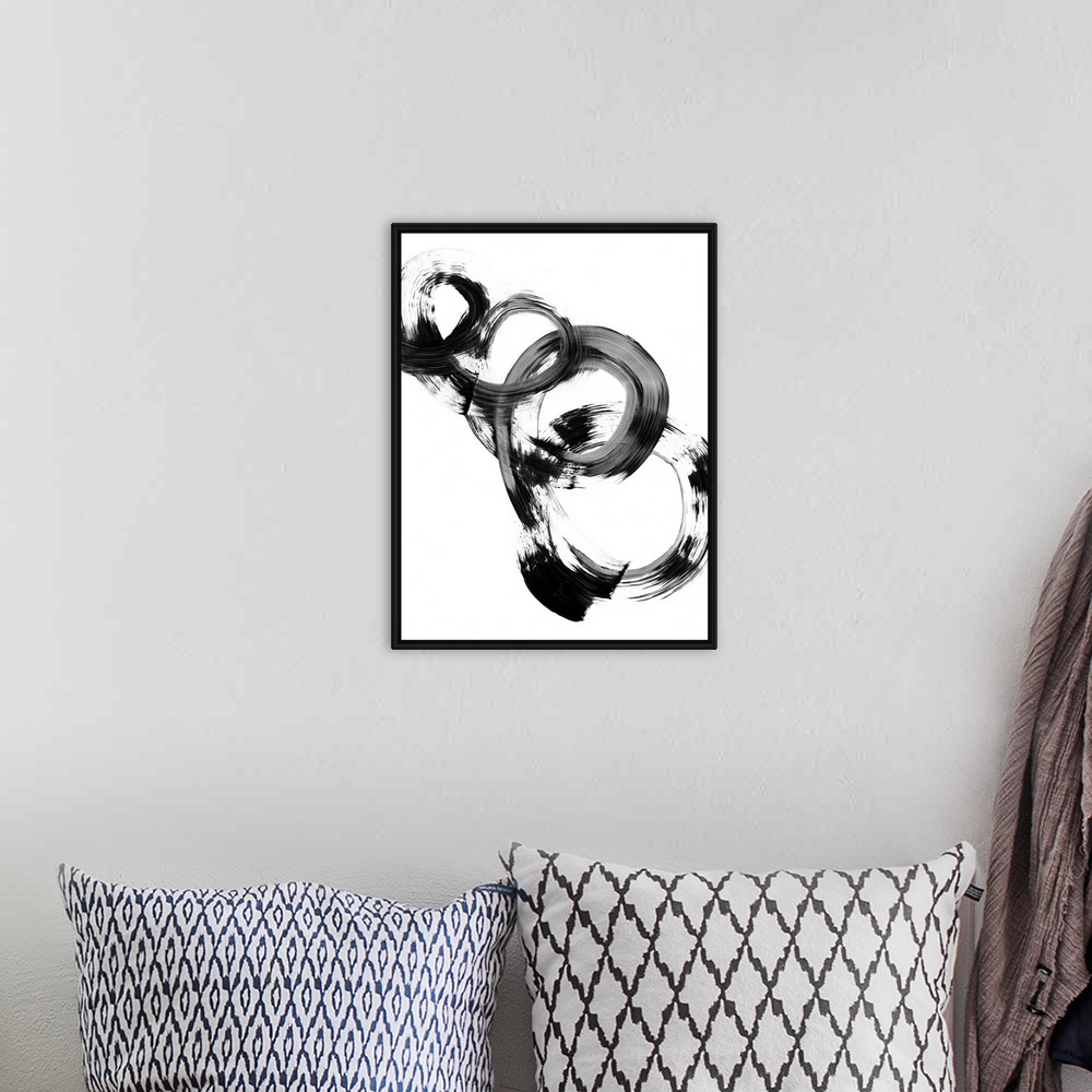 A bohemian room featuring Contemporary abstract painting of interlocking circular shapes in black and white.