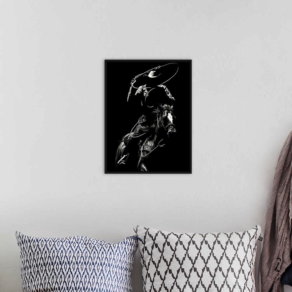 A bohemian room featuring Black and white lifelike illustration of a cowboy riding a horse with a lasso.