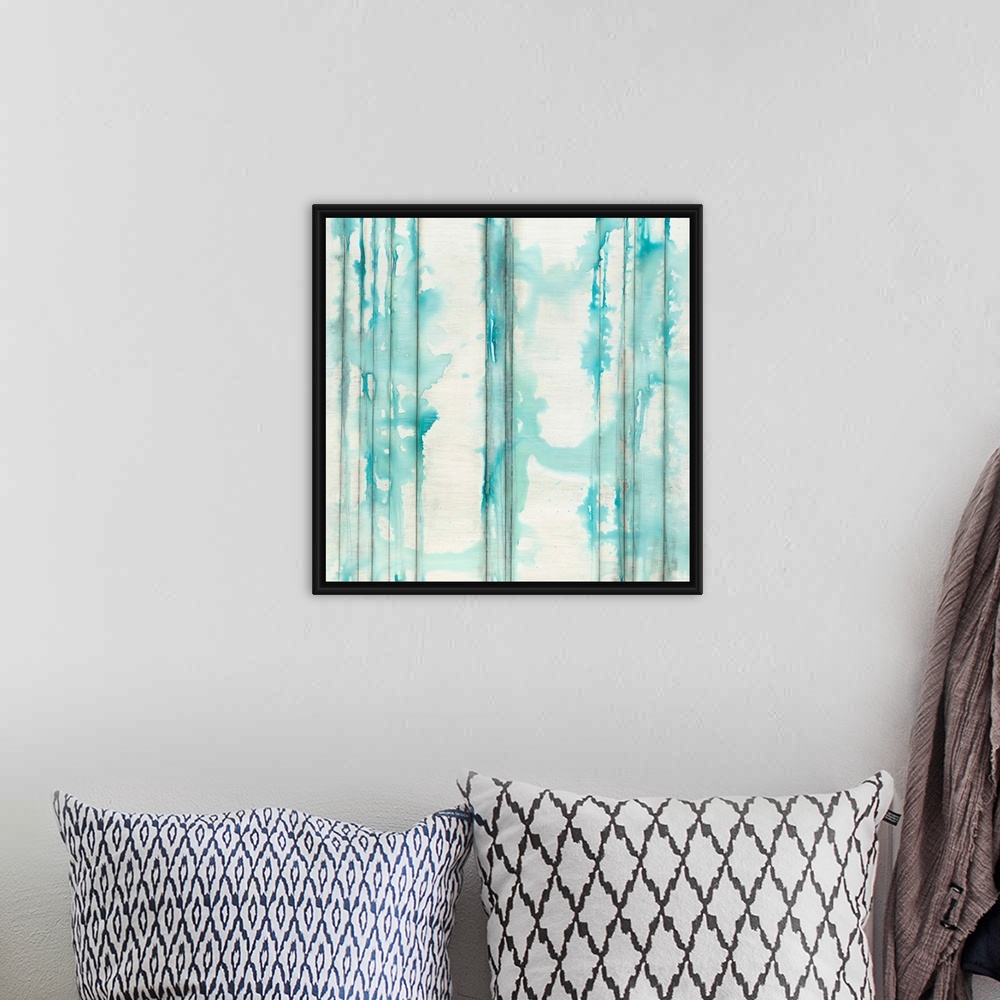 A bohemian room featuring Square abstractly painted canvas of vertical lines with splattered watercolor paint on top.