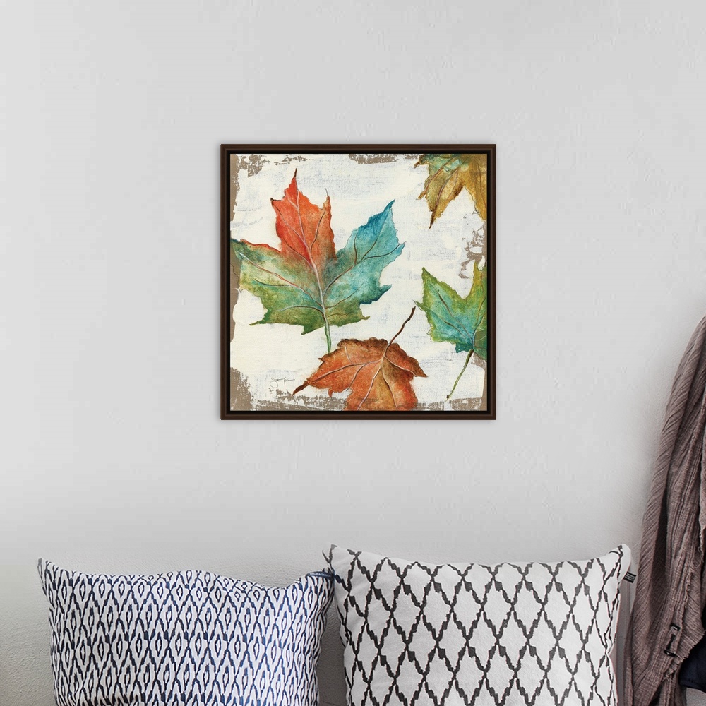 A bohemian room featuring Autumn home decor artwork with multicolored Fall leaves.
