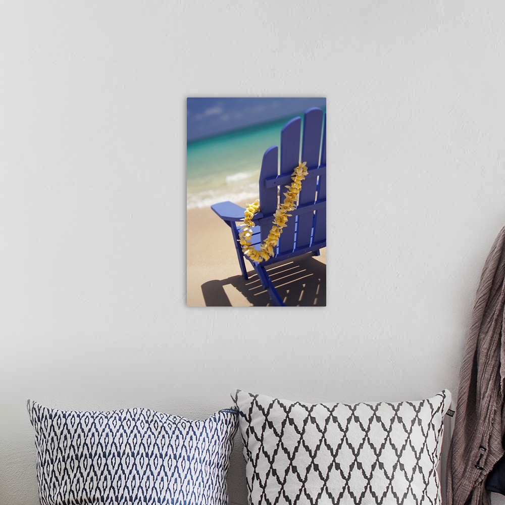 A bohemian room featuring Blue Beach Chair With Plumeria Lei Hanging On Side