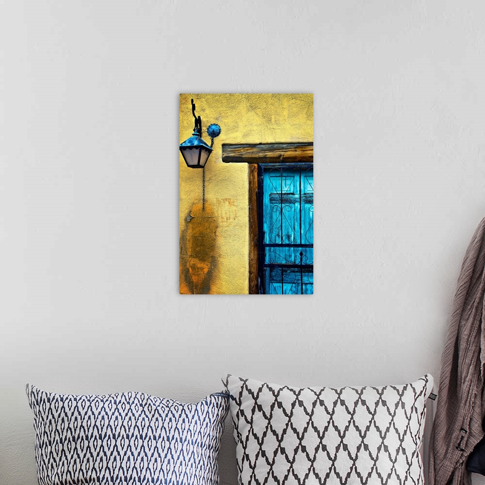 A bohemian room featuring Vertical panoramic photograph of bright colorful door on stone wall.