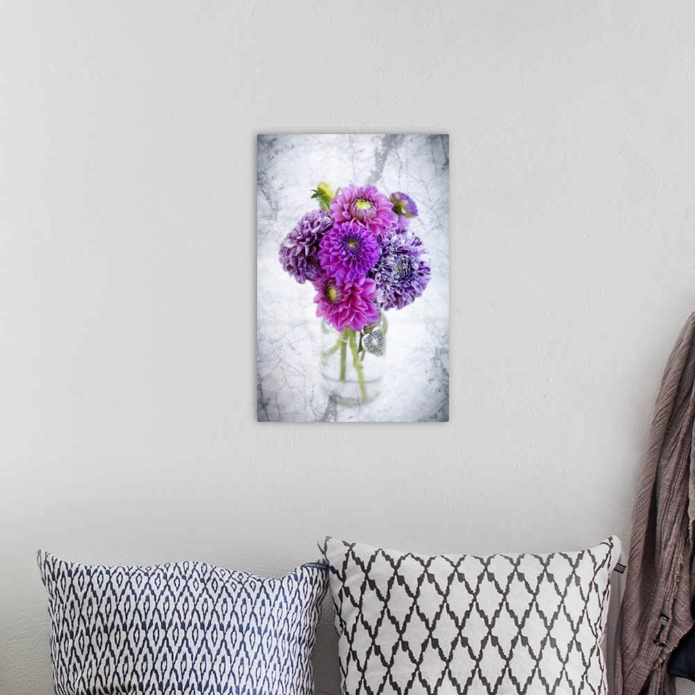 A bohemian room featuring Purple marbled dahlia's arranged in a glass jar on a marble counter