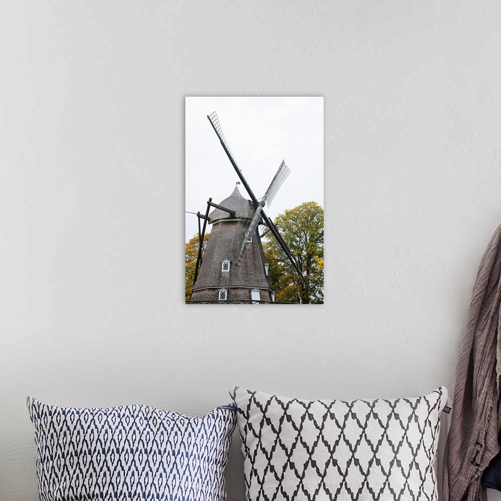 A bohemian room featuring Copenhagen, Denmark - A historic old style windmill after having been restored. Vertical shot.