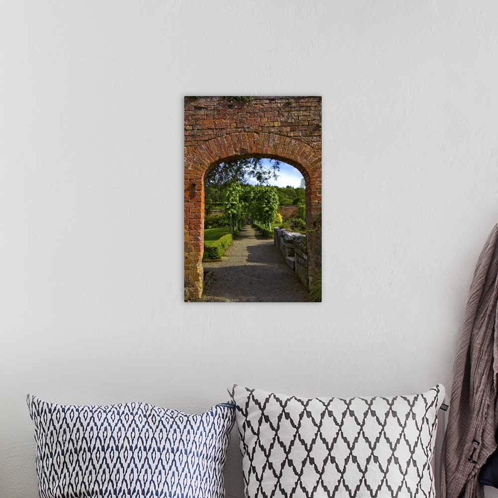 A bohemian room featuring In Ireland,the Dromoland Castle Walled Garden path through a brick archway no people