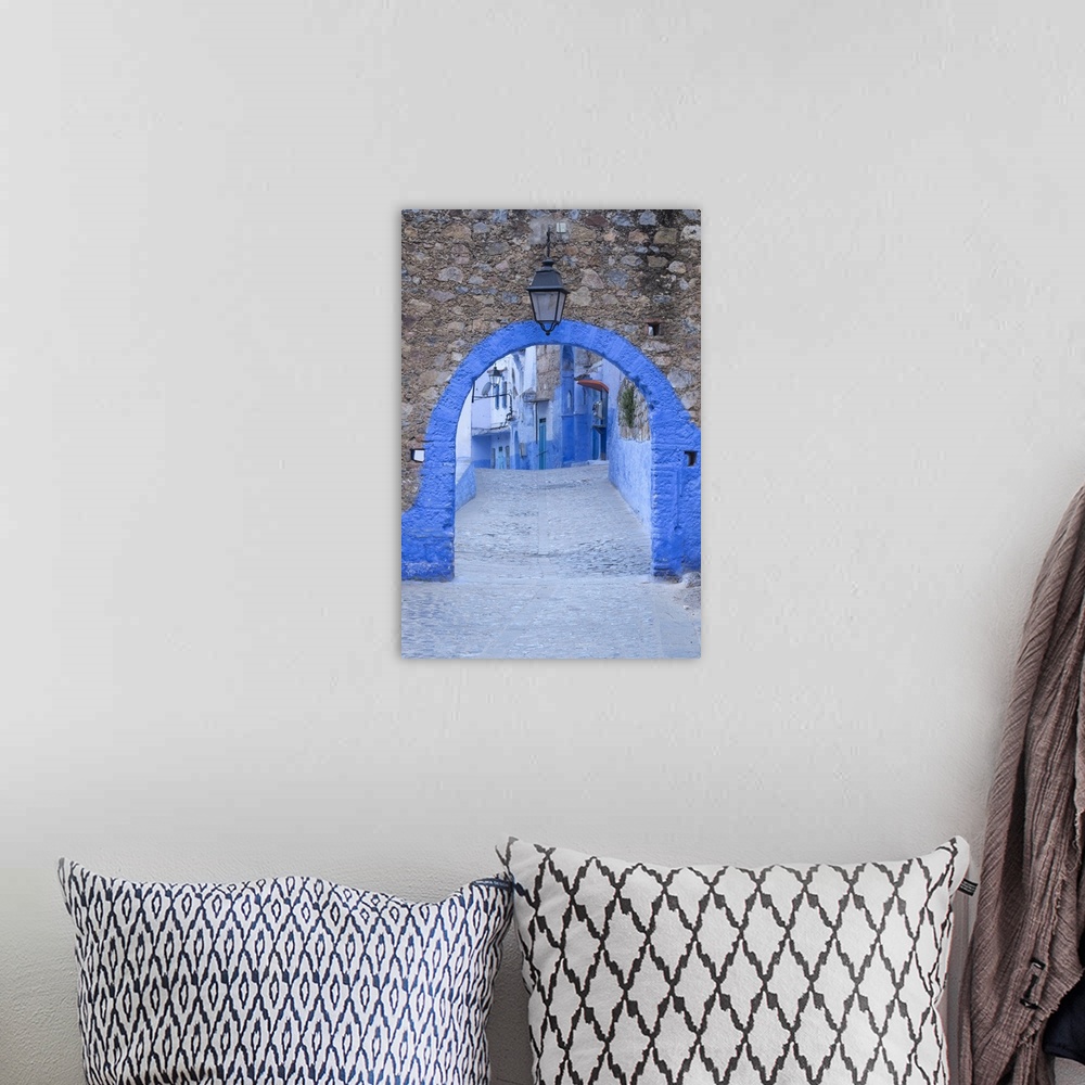 A bohemian room featuring Morocco, Chefchaouen. A blue arch and quiet street entering the medina of the village.