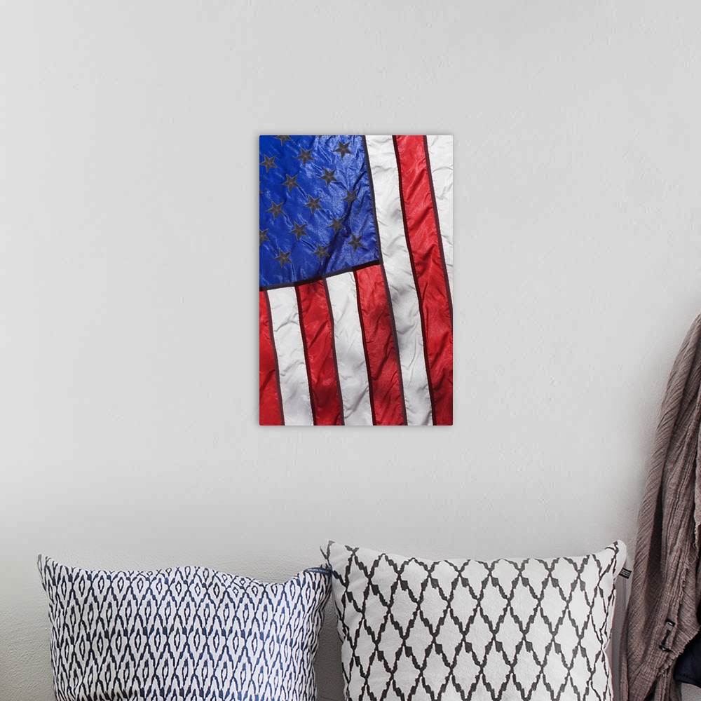 A bohemian room featuring Sunlight shines through an American Flag.